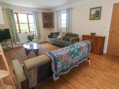 A living room with a sofa and coffee table at Yonde View in Camborne