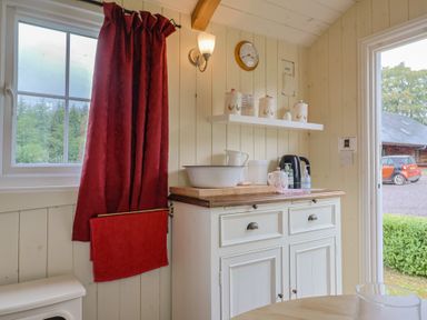A kitchen space with a cabinet and kettle at Shepherds Hut at East Hill Pride in Four Elms Hill Nr. Sidmouth