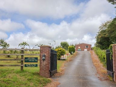 An entrance with a gate and a sign at Shepherds Hut at East Hill Pride Four Elms Hill Nr. Sidmouth