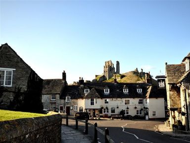 An outdoor view of buildings and a castle at Little Wickers in Wareham