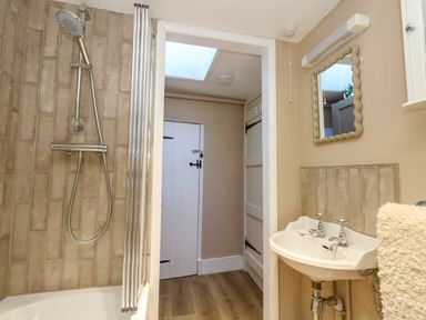 A bathroom with a shower and a sink at Little Wickers in Corfe Castle