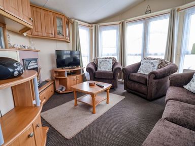 A living room with a television and sofas at Winchester - 478 Abergele
