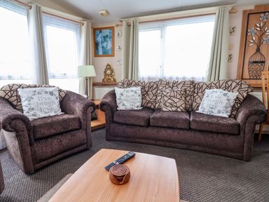 A living room with sofas and a coffee table at Winchester - 478 Abergele