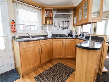 A kitchen with a sink and appliances at Winchester - 478 Abergele