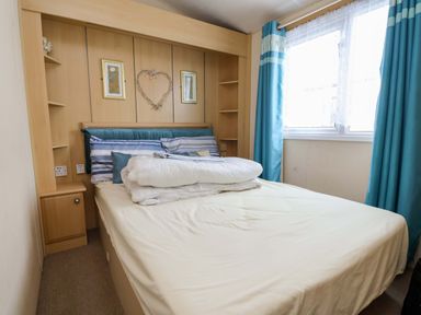 A bedroom with a bed and shelves at Winchester - 478 Abergele