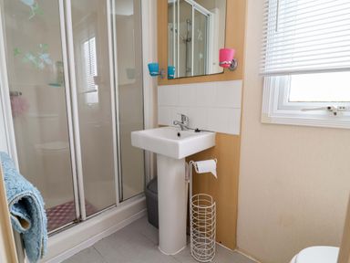A bathroom with a shower and sink at Winchester - 478 Abergele