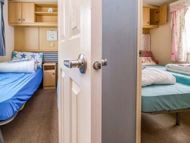 A bedroom with two beds and shelves at Winchester - 478 Abergele