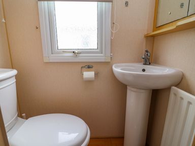 A bathroom featuring a toilet and wash basin at Winchester - 478 in Abergele