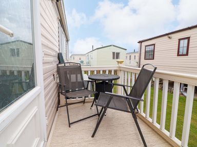 A balcony with a table and chairs at Winchester - 478 Abergele