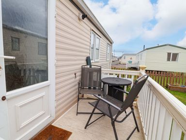 An outdoor area with a chair and a table at Winchester - 478 Abergele