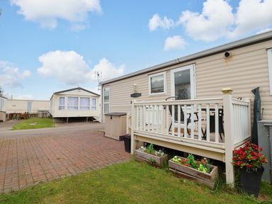An outdoor area with a deck and caravan at Winchester - 478 Abergele