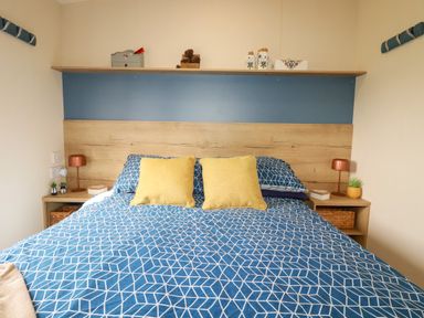 A bedroom with a bed and shelf at 5 Silverbow