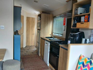 A kitchen with appliances and storage in Porthcurno 5 Perranwell near Goonhavern