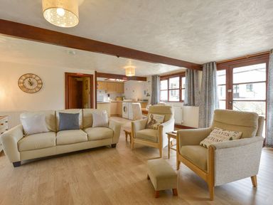 A living room with a sofa and armchairs at Pillhead Cart Linhay in Bideford