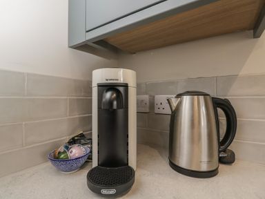 A kitchen with a Nespresso machine and an electric kettle at Foxglove in Stratton Audley near Bicester