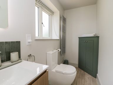 A bathroom with a toilet and sink at Foxglove in Stratton Audley near Bicester