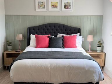 A bedroom with a bed and nightstands at Foxglove in Stratton Audley near Bicester