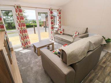 A living room with sofas and a coffee table at Sandpiper in Narberth