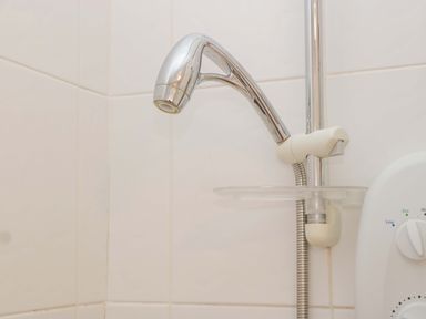 A showerhead and control unit in a bathroom at Halsdon Avenue Exmouth