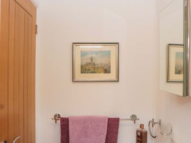 A bathroom with a framed picture and towel rack at Halsdon Avenue in Exmouth