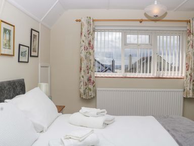 A bedroom with a bed and window at Halsdon Avenue in Exmouth