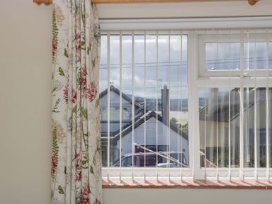 A window with a view of houses and landscape at Halsdon Avenue in Exmouth