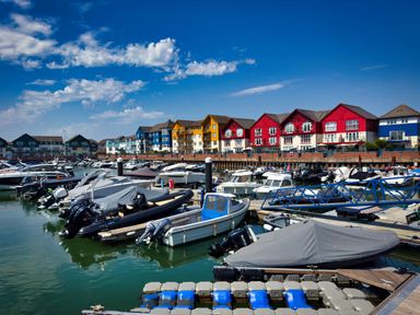 A marina with boats and residential buildings at Halsdon Avenue in Exmouth