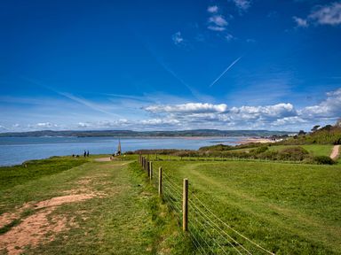 A landscape view of grass and ocean at Halsdon Avenue in Exmouth