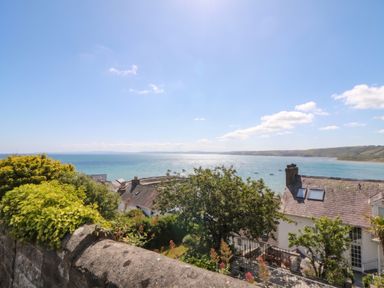 An outdoor view of the sea and houses at Arosfa New Quay