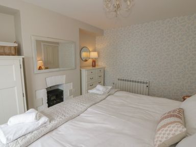 A bedroom with a bed and furniture at Arosfa New Quay