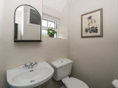 A bathroom with a sink and toilet at Arosfa in New Quay