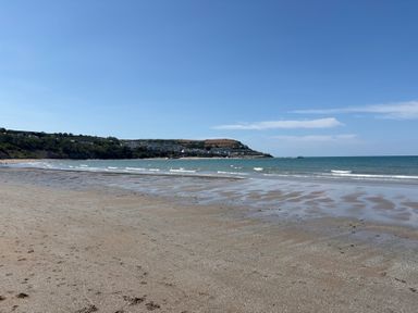 A beach with sand and water at Arosfa New Quay
