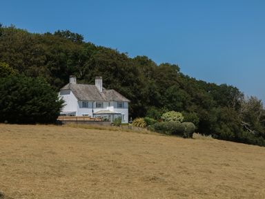 A house with a garden and trees at The White House in Okehampton