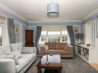 A living room with a sofa and window at The White House in Okehampton