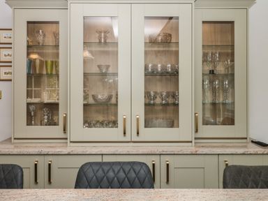 A glass cabinet with crystal items and glasses at The White House Okehampton