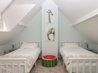 A bedroom with two beds and animal artwork at The White House in Okehampton
