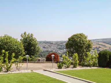 A garden with trees and bushes at The White House in Okehampton