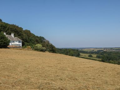 A house on a hillside surrounded by fields at The White House in Okehampton
