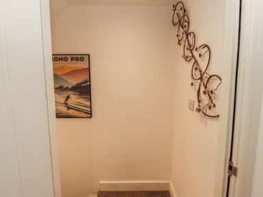 A hallway with a poster and wall decoration at Hidden Gem