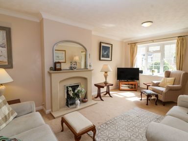 A living room with a fireplace and television at Number 10, Broadway