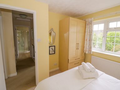 A bedroom with a bed and wardrobe at Number 10, Broadway