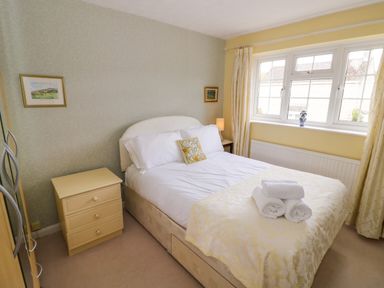 A bedroom with a double bed and window at Number 10, Broadway