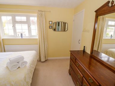 A bedroom with a bed and dresser at Number 10, Broadway