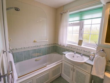 A bathroom with a bathtub and sink at Number 10, Broadway