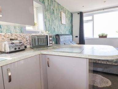 A kitchen featuring a toaster and microwave at Two Bed Apartment No.4 Newquay