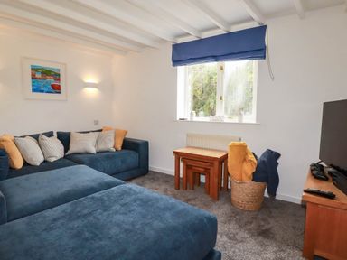 A living room with a sofa and coffee table at Little House in Wadebridge