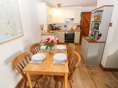 A kitchen with wooden table and chairs at The Old Dairy near Solva