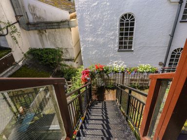 A staircase leading down with plants and flowers at 15D Foss Street Dartmouth