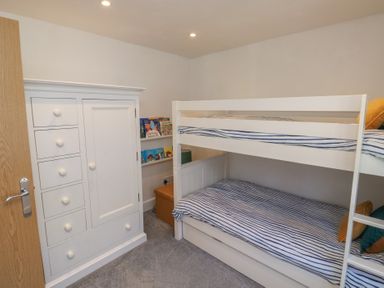 A bedroom with a bunk bed and a chest of drawers at 15D Foss Street in Dartmouth