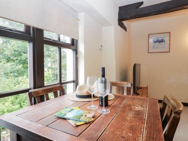 A dining room with a table and chairs at Flat 4 Grasmere Lodge in Ambleside